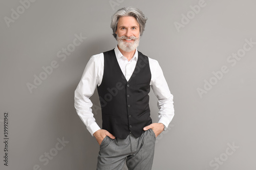 Handsome mature man on grey background