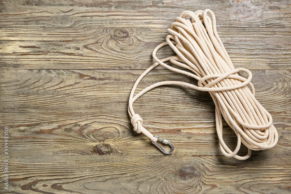 Rope with lobster clasp on wooden background Rope with lobster clasp on wooden background