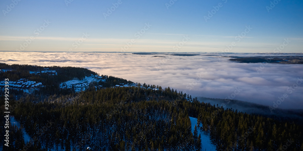 Arial: Photo shot with a drone. Fog in the valley below.  Norway, Oslo, Holmenkollen.