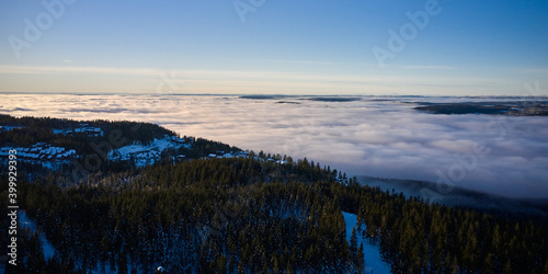 Arial: Photo shot with a drone. Fog in the valley below. Norway, Oslo, Holmenkollen.