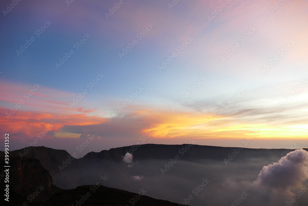 Sunrise view from the summit of Mount Rinjani. In the background is the Island of Sumbawa and Mount Tambora