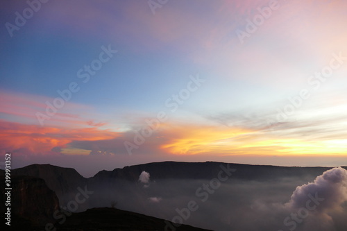 Sunrise view from the summit of Mount Rinjani. In the background is the Island of Sumbawa and Mount Tambora