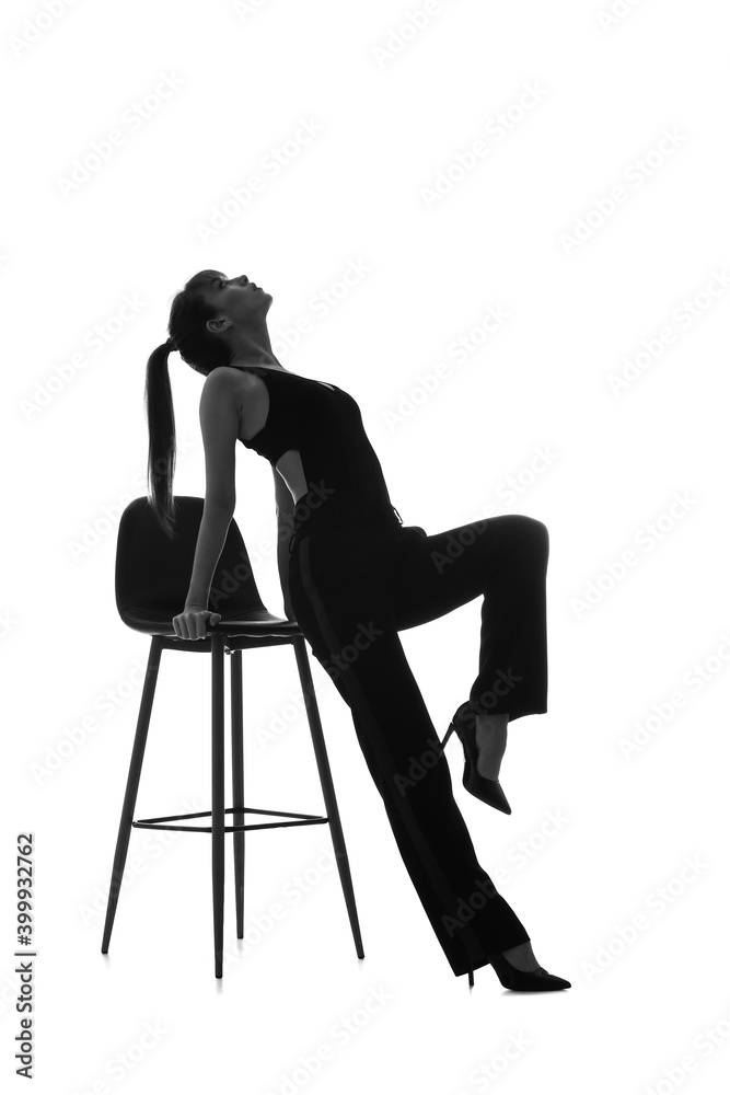 Silhouette of beautiful young woman with chair on white background Silhouette of beautiful young woman with chair on white background