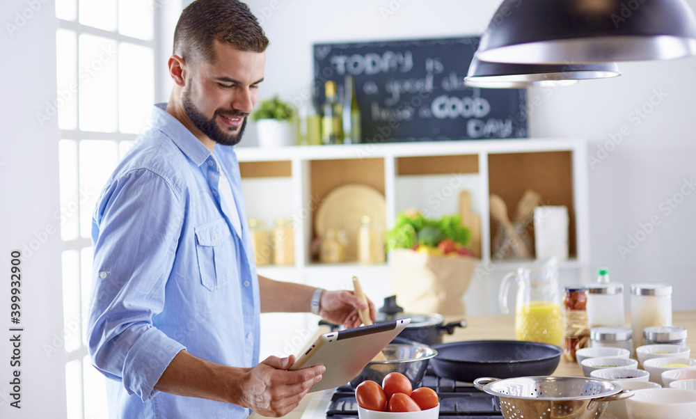 Smiling and confident chef standing in large kitchen Smiling and confident chef standing in large kitchen