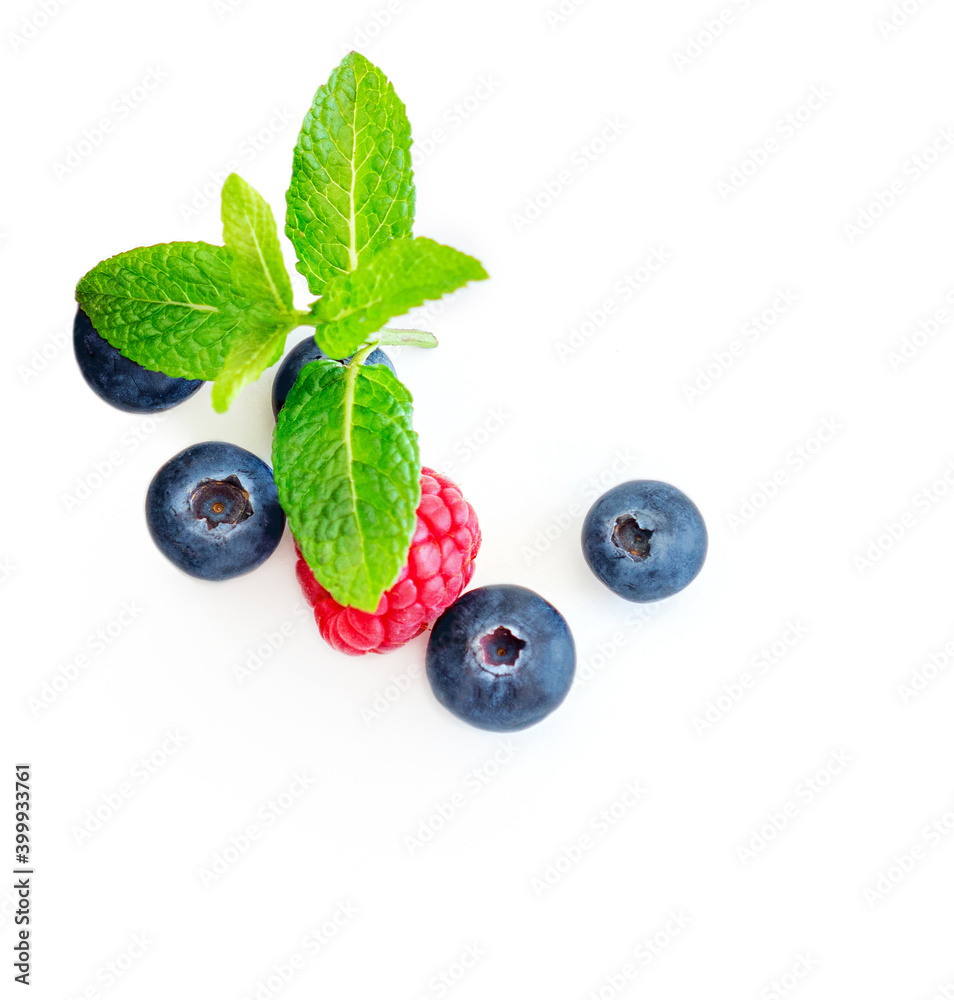 Fresh mix berries isolated on white background. Raspberry, Blueberry and Mint leaf, flat lay. Top view. Food creative layout. Fresh mix berries isolated on white background. Raspberry, Blueberry and Mint leaf, flat lay. Top view. Food creative layout.