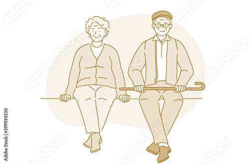 Senior elderly couple living happy active lifestyle concept. Happy mature aged couple pensioners woman and man sitting together on bench during walk looking at camera. Retiree, pensioner happiness
