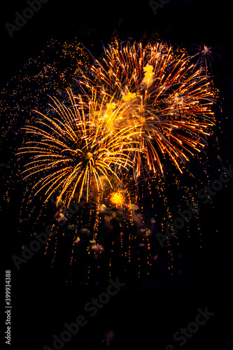 Fireworks light up  at New Year Eve. Abstract Festive background with fireworks sparkles. Copyspace.