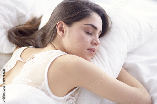 beautiful young woman basking in bed in the morning. Beautiful Model face looks sexy in camera