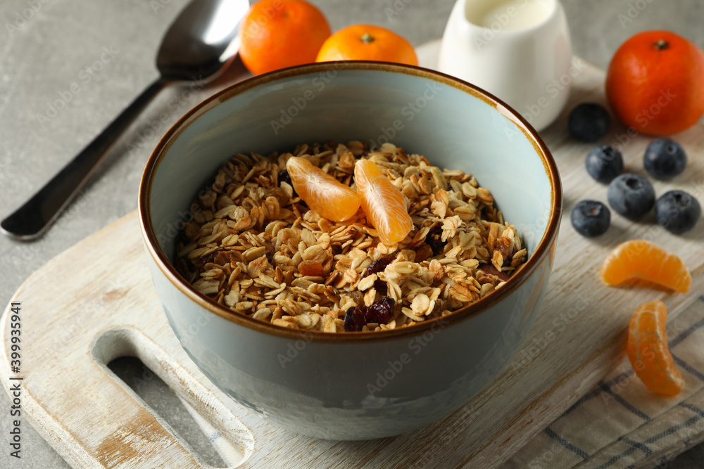 Fototapeta premium Concept of tasty breakfast with granola on gray background