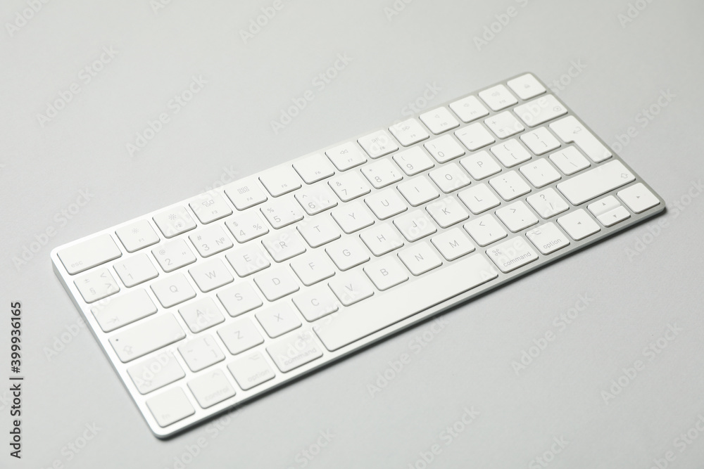 Modern computer keyboard on gray background, close up Modern computer keyboard on gray background, close up