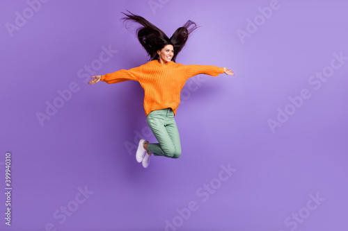 Full length body size photo of girl jumping hands like wings childish looking blank space isolated on bright purple color background