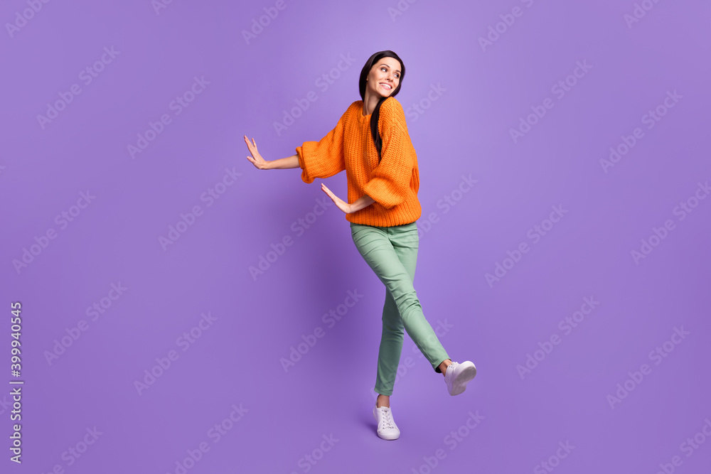 Full length body size photo of dancing brunette on dancefloor in casual clothes looking at side isolated on bright violet color background