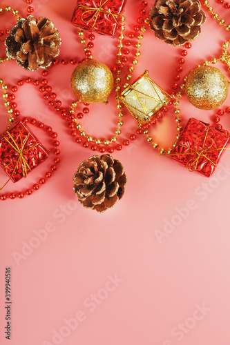 Christmas composition of decorations and Christmas toys on a pink background