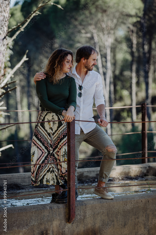Engagement photo session of a young couple in the countryside. Caucasian couple, with a modern style.  Family enjoying tender moment, happy marriage. family concept.