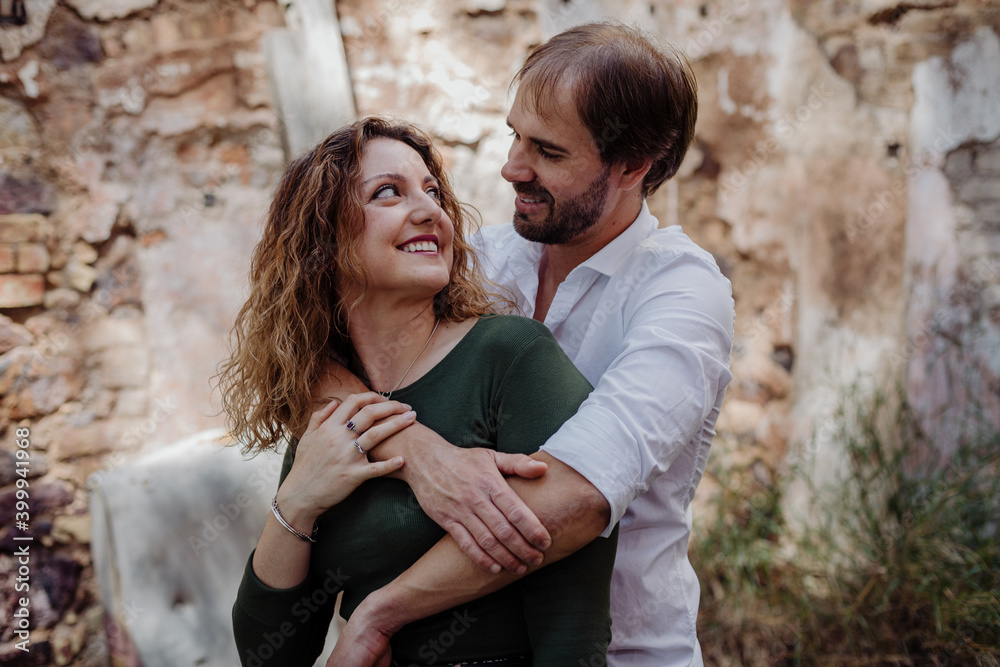 Engagement photo session of a young couple in the countryside. Caucasian couple, with a modern style. Family enjoying tender moment, happy marriage. family concept