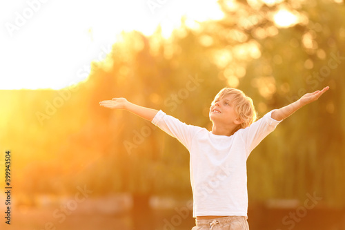 Cute little boy outdoors at sunset. Child spending time in nature