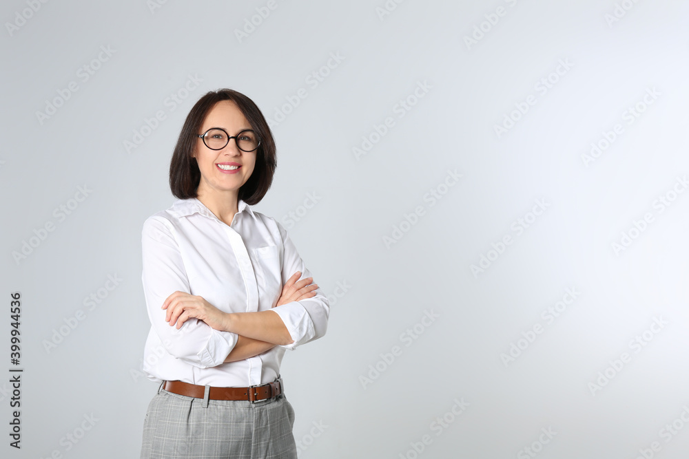 Portrait of mature businesswoman on light grey background. Space for text Portrait of mature businesswoman on light grey background. Space for text