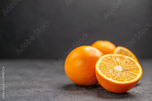 Horizontal view of fresh whole and sliced lemons on dark background stock image
