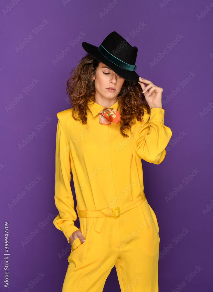 Fashionable woman in yellow 80s suit and hat Fashionable woman in yellow 80s suit and hat