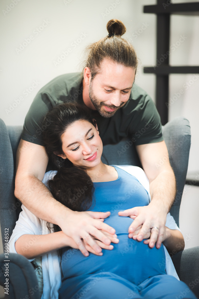 Happy pregnant couple waiting for baby at home, Pregnant couple of husband and wife Happy pregnant couple waiting for baby at home, Pregnant couple of husband and wife
