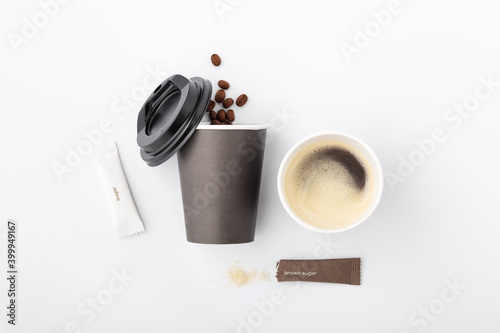 Coffee in black paper cup with sugar