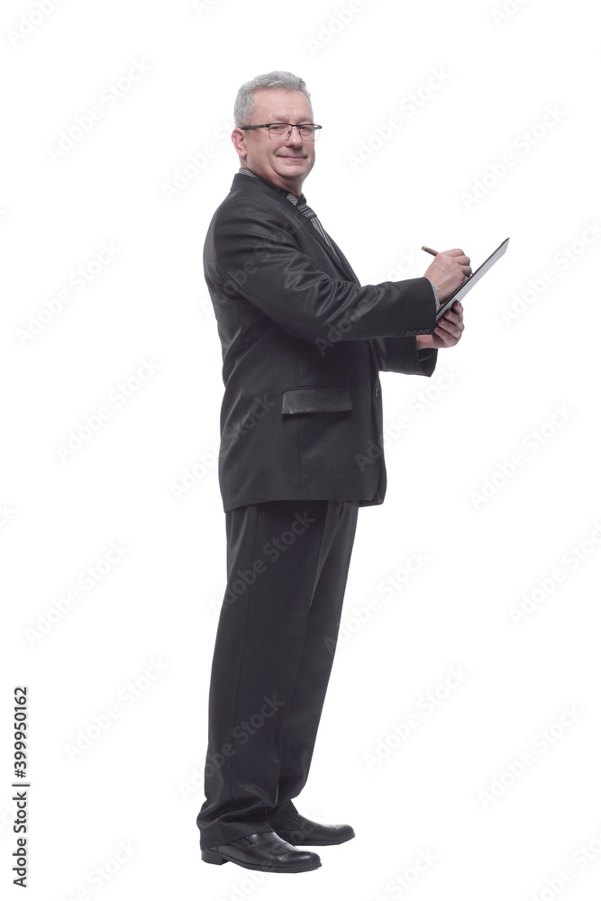 Side view of attractive businessman holding clipboard and writin