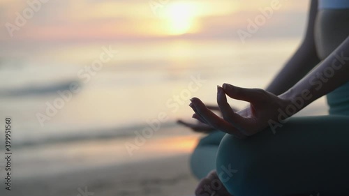 Happy woman doing yoga practice on beach sunset