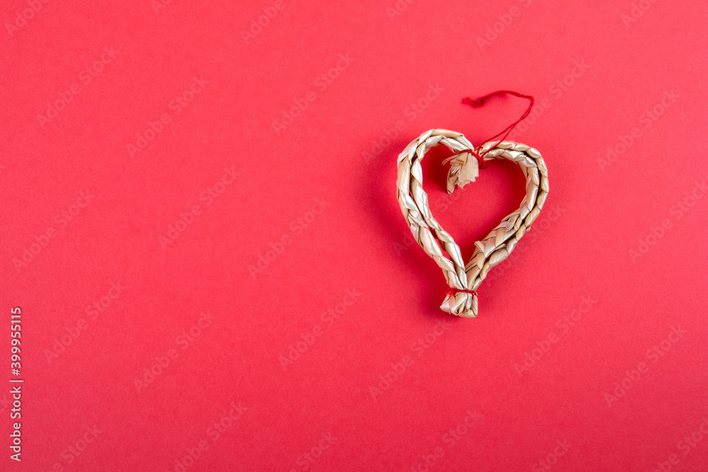 Straw decoration in the shape of a heart. Christmas or valentines day background Straw decoration in the shape of a heart. Christmas or valentines day background