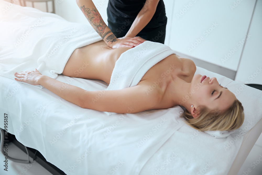 Fototapeta premium Good looking young woman enjoying professional treatment in medical center