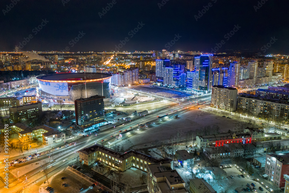 Naklejka premium Aerial view of the night modern city and stadium. Bright lights of the night streets. Ekaterinburg. Russia