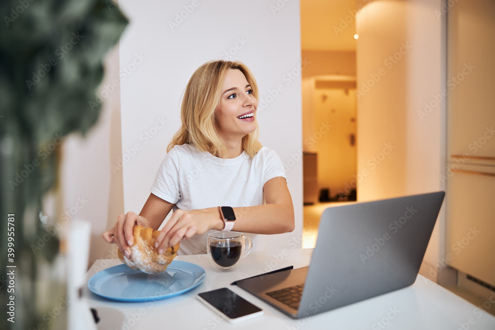 Positive delighted woman enjoying her cozy morning Positive delighted woman enjoying her cozy morning