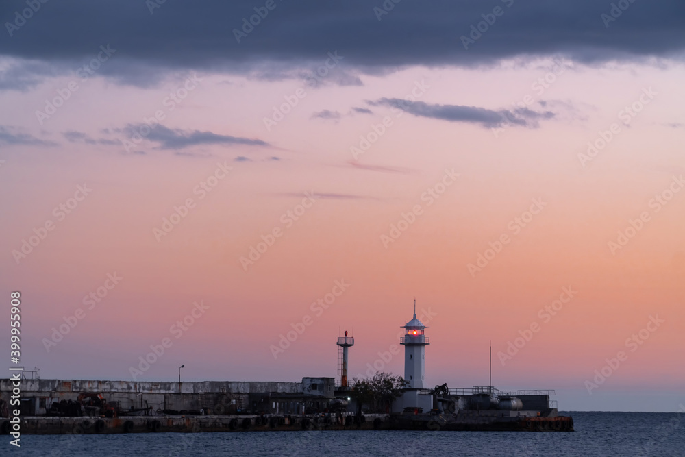 Yalta lighthouse against the background of a pink evening sky