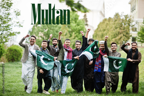 Multan city. Group of pakistani man wearing traditional clothes with national flags. Biggest cities of Pakistan concept. photo