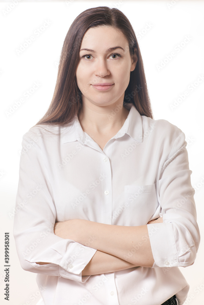 Brunette woman in a white shirt with crossed arms Brunette woman in a white shirt with crossed arms