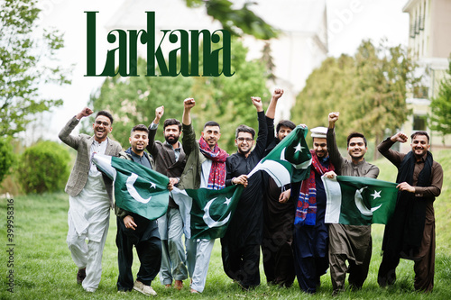 Larkana city. Group of pakistani man wearing traditional clothes with national flags. Biggest cities of Pakistan concept.