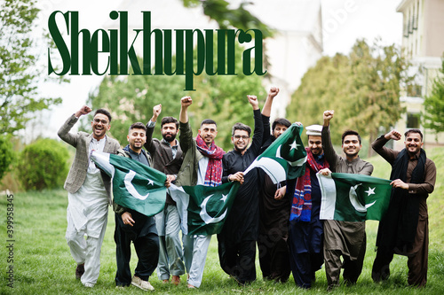 Sheikhupura city. Group of pakistani man wearing traditional clothes with national flags. Biggest cities of Pakistan concept.