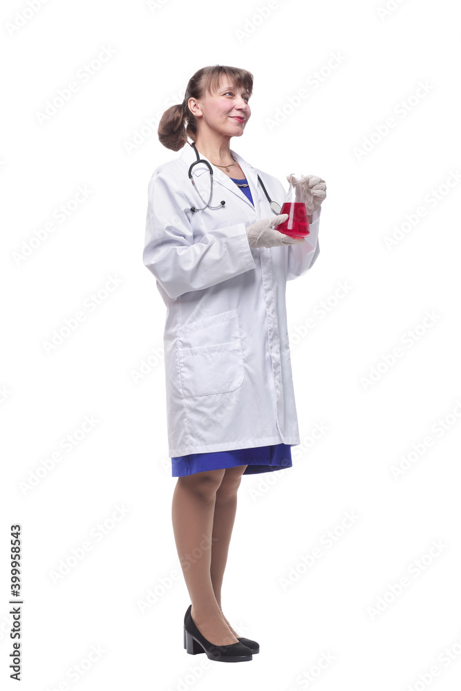 Female scientist looking at beaker of red liquid Female scientist looking at beaker of red liquid