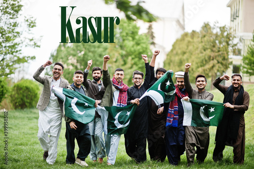 Kasur city. Group of pakistani man wearing traditional clothes with national flags. Biggest cities of Pakistan concept.