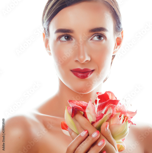 young pretty brunette real woman with red flower amaryllis close up isolated on white background. Fancy fashion makeup  bright lipstick  creative Ombre manicured nails