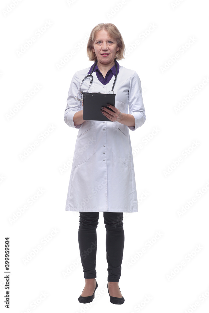 Attractive female doctor standing and doing paperwork Attractive female doctor standing and doing paperwork