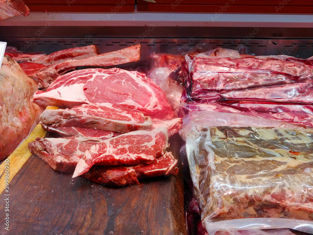 Large choice of different cuts of fresh raw red meat at farmers market