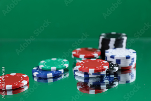 Wallpaper Mural Close up of poker playing chips falling on a green table under the water drops against green background Online gambling. Addiction. Casino. Torontodigital.ca