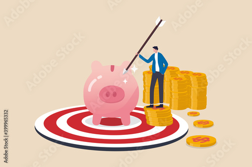 Financial goal or target, success in saving and investment or achieve finance independence concept, happy businessman investor holding arrow on stack of coins with piggy bank on bullseye dartboard.