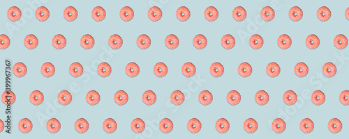 Banner of a yummy pinks donuts with colorful sprinkles on blue background.