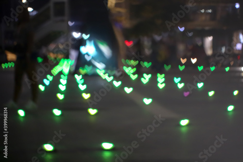 green bokeh and blur heart shape love valentine colorful night light on floor