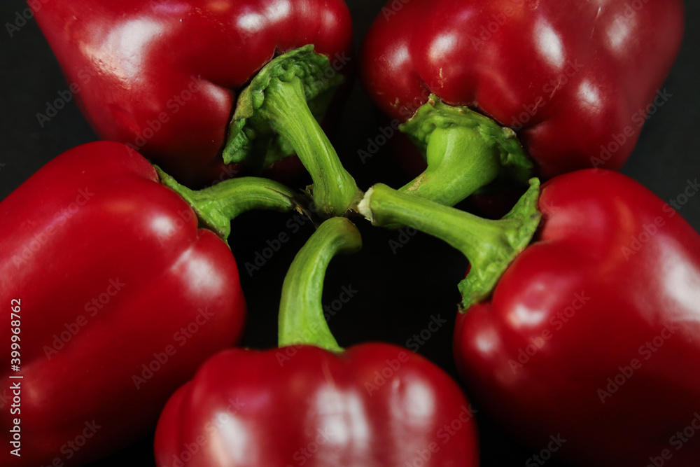 Red peppers on black background