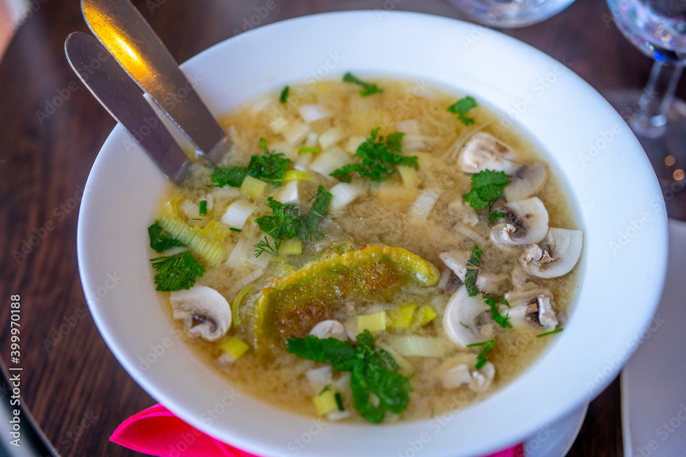 Noodle Bowl With vegetables and dumplings. Close up of a bowl Chinese style on wooden background .