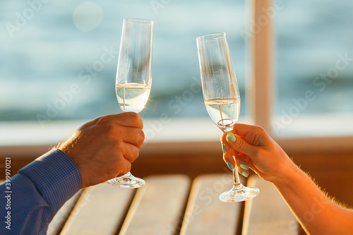 Happy couple drinks champagne on a yacht.