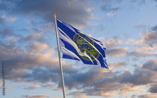 Nebraska US State Flag at sky background.