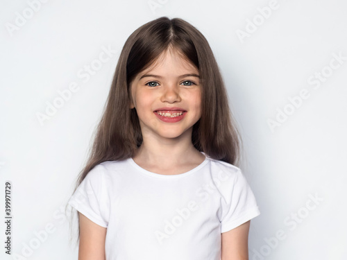 t-shirt design concept - cute smiling happy little girl in blank white t-shirt 